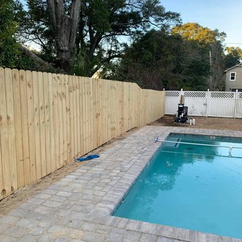new wood fence installed next to a pool