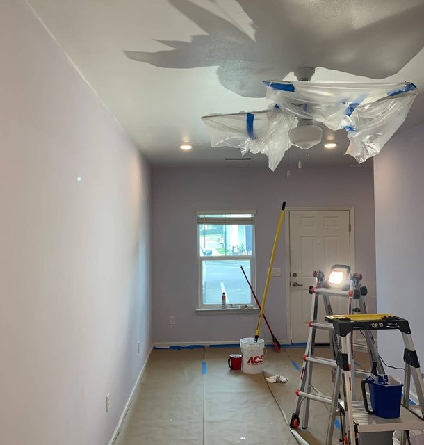 interior painting prep with drop cloths and ladder